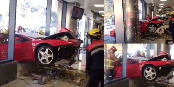 Ferrari 512 Testarossa contro la vetrata di un centro commerciale