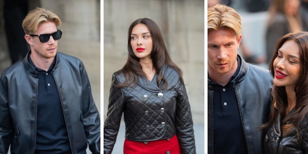 Occhiali da sole e giacca di pelle: De Bruyne super star alle sfilate di Parigi. E la moglie Michele in rosso sexy strega tutti